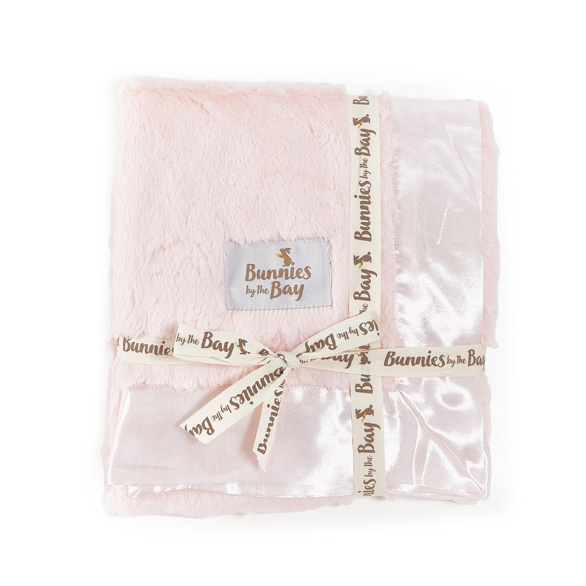 Folded Pink baby blanket with 'Bunnies by the Bay' branded patch and ribbon on a white background