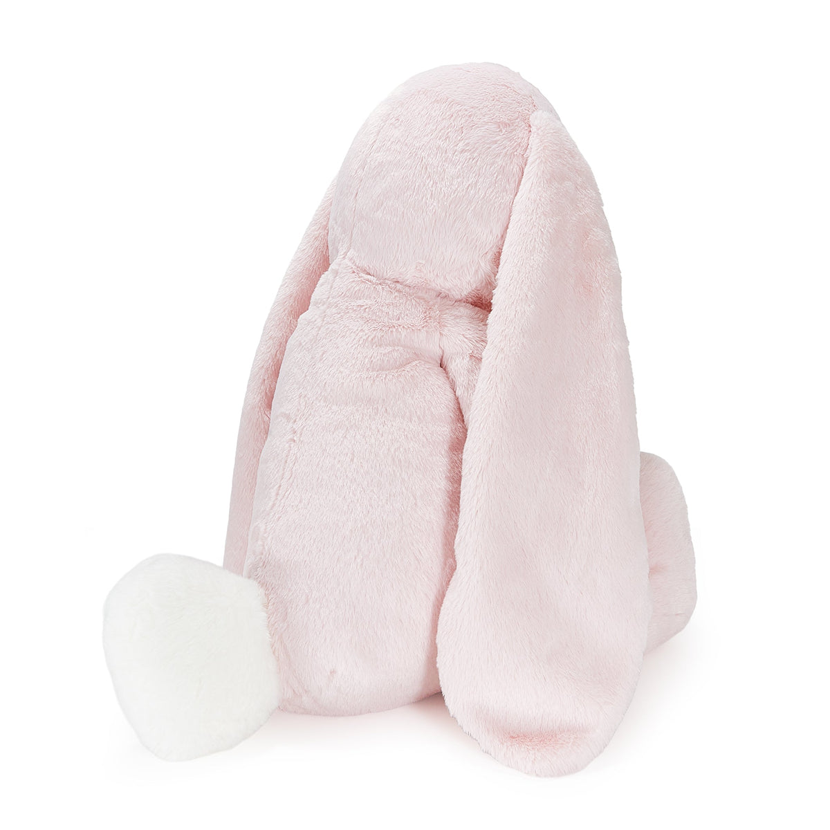 A light pink plush bunny toy with long floppy ears and a white fluffy tail, photographed against a clean white background.