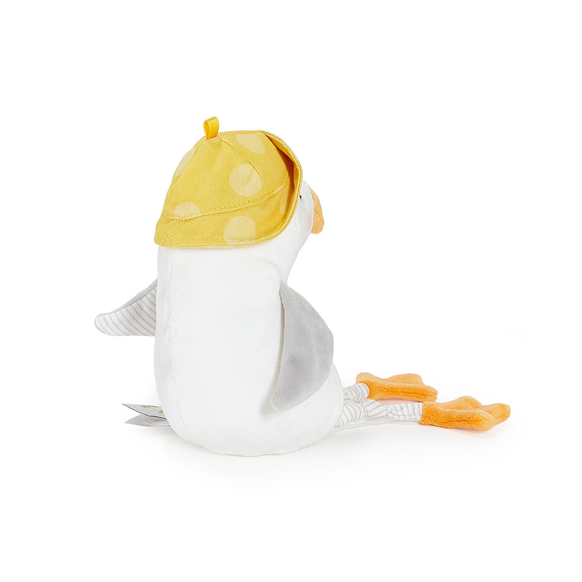 A plush penguin toy shown from the back, wearing a yellow polka-dot cap, with a white body, gray wings, and orange feet, photographed on a clean white background.