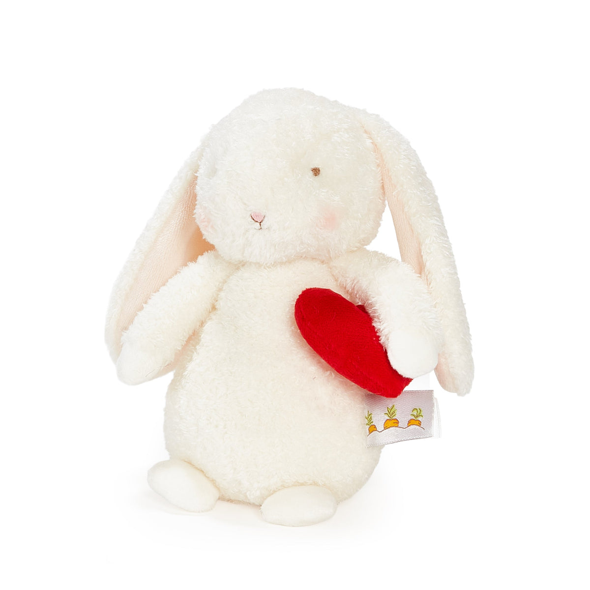 A plush white bunny toy holding a red heart, photographed on a clean white background. The bunny has long floppy ears, embroidered facial features, and a small fabric tag attached near the lower right side.