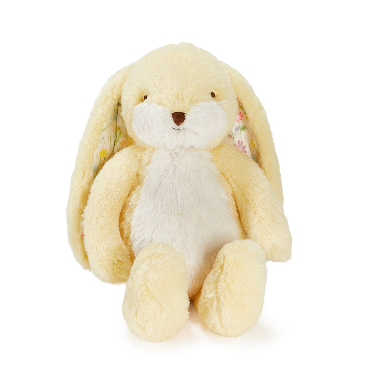 A soft plush bunny toy in pale yellow and white, with long floppy ears, a small brown nose, and tiny floral details in the inner ears, photographed on a clean white background.