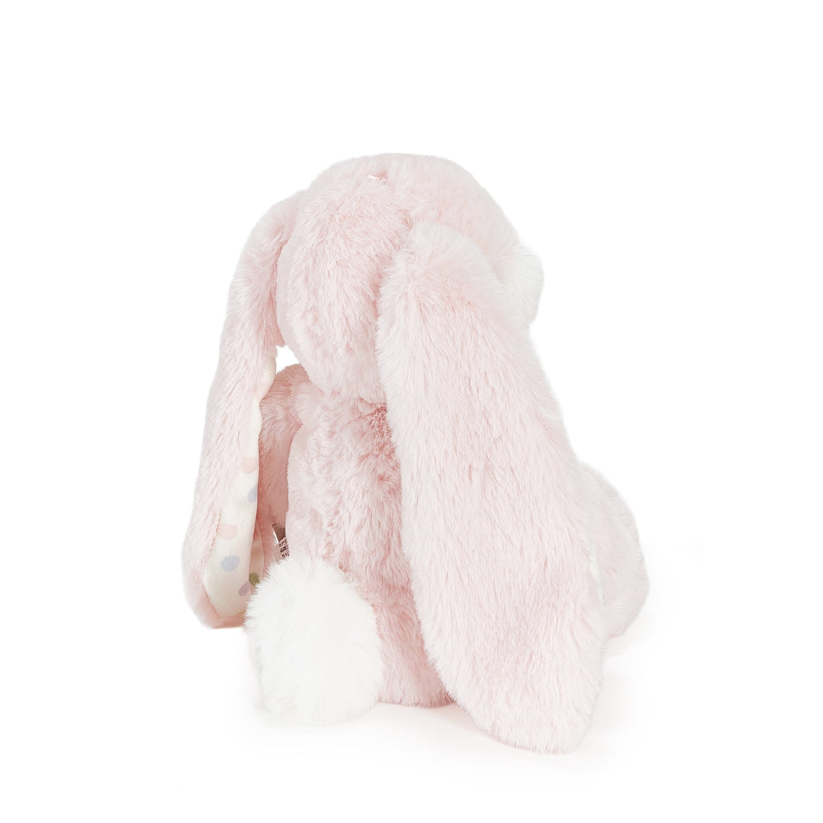 A light pink plush bunny toy with long floppy ears and a white fluffy tail, photographed on a clean white background.
