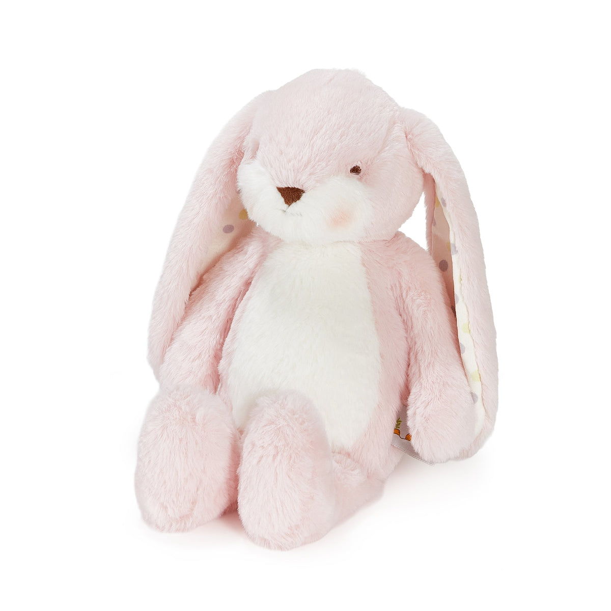 A soft pink plush bunny toy with long floppy ears, a white belly, and a small brown stitched nose, photographed on a clean white background.