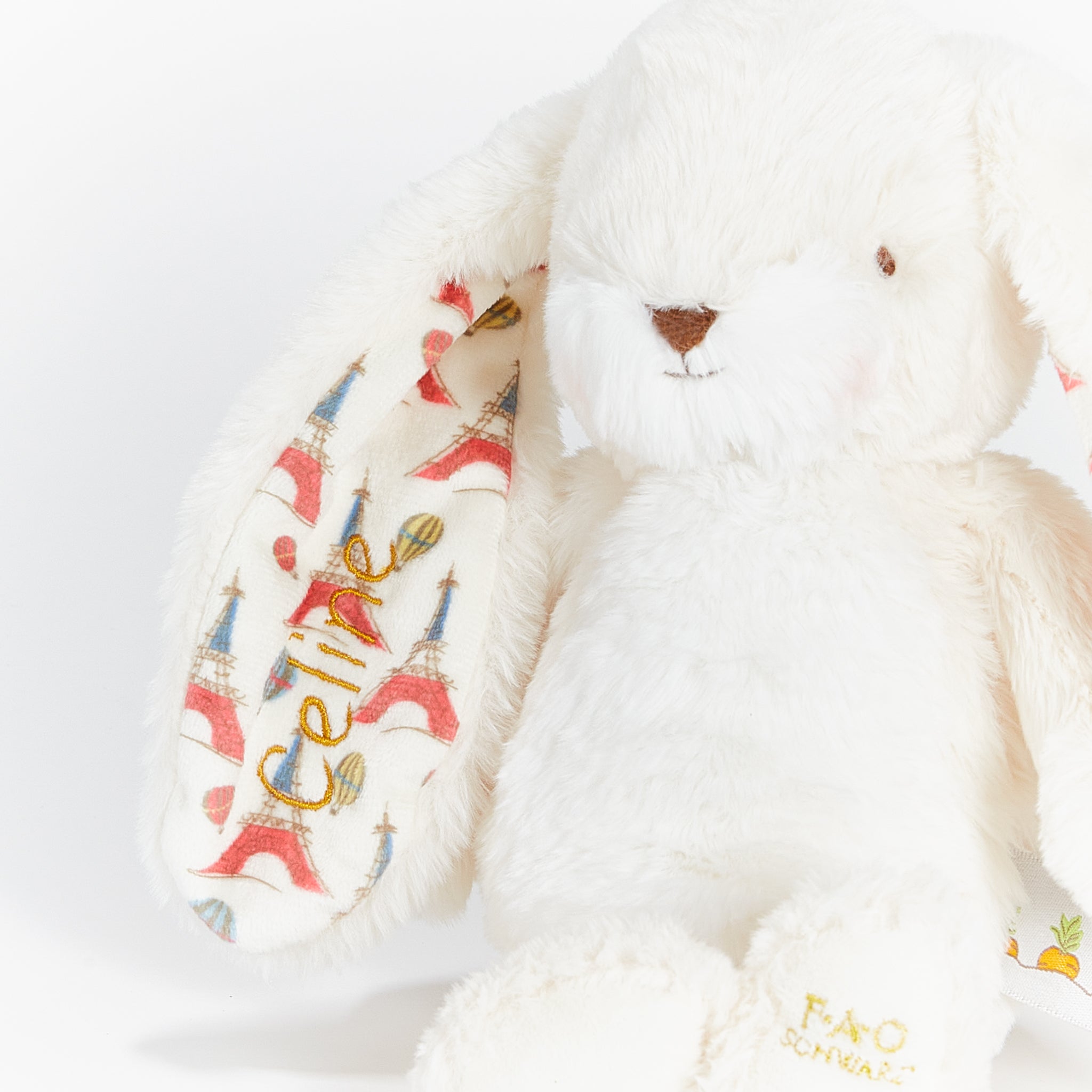 White plush bunny with Eiffel Tower design on a white background