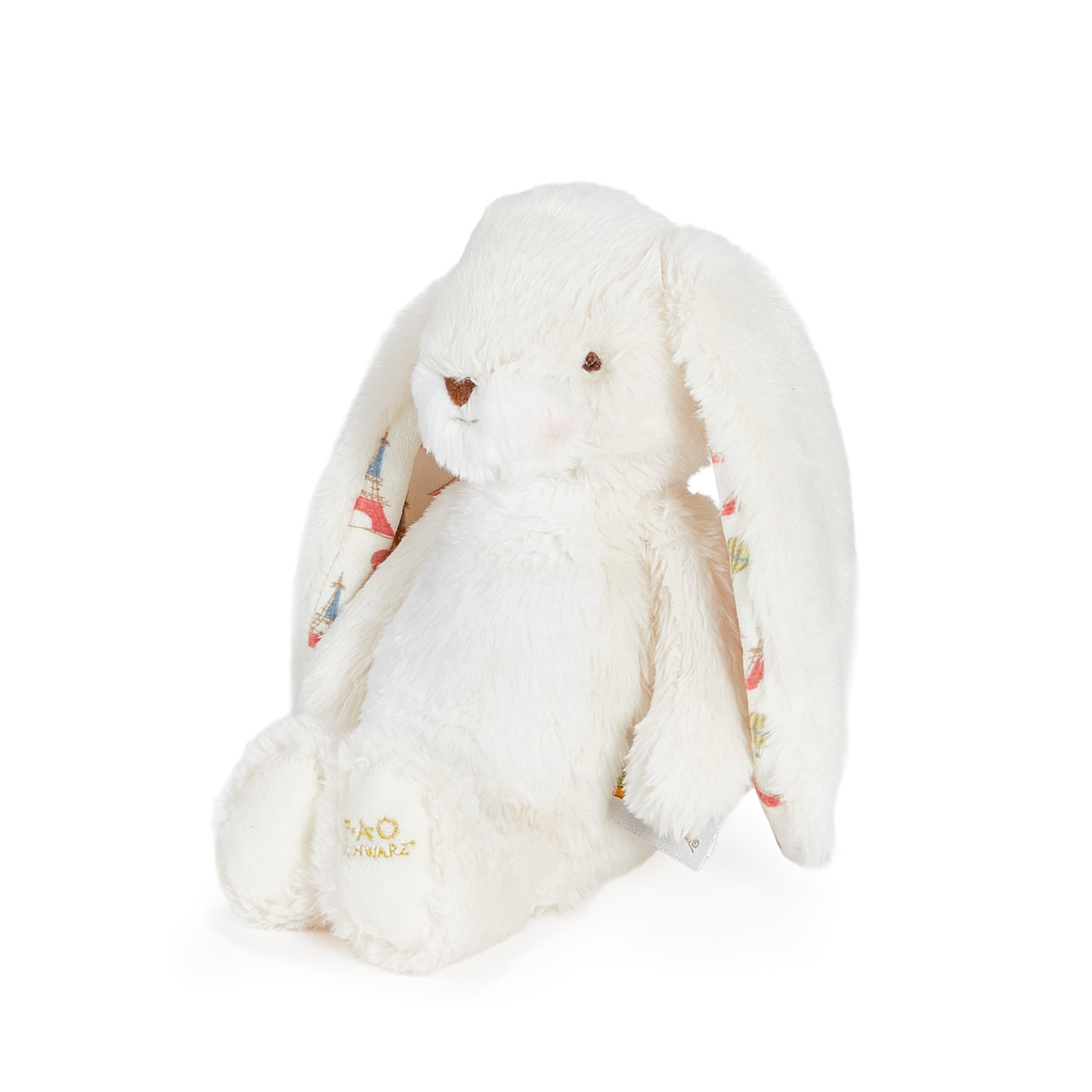 White plush bunny toy with floral pattern on a white background