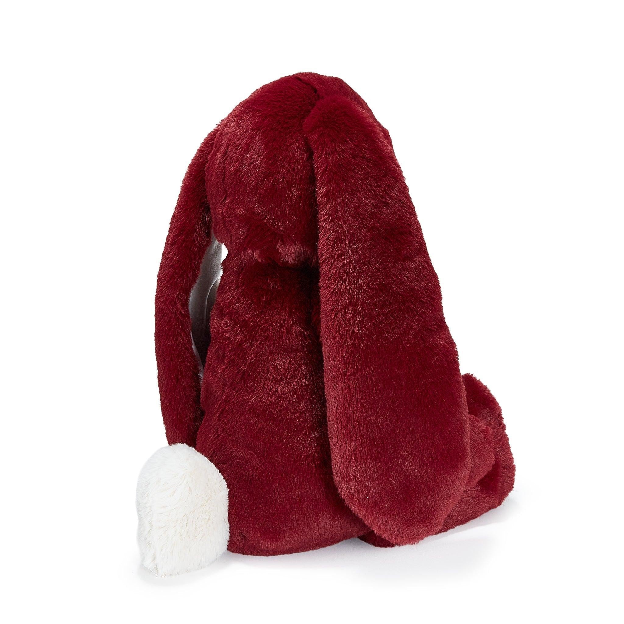 Red plush toy with a white tail on a white background