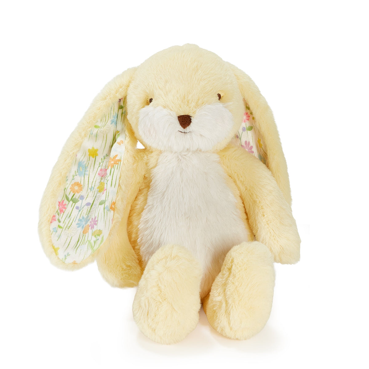 A soft plush bunny toy in pale yellow and white, with long floppy ears, a small brown nose, and tiny floral details in the inner ears, photographed on a clean white background.