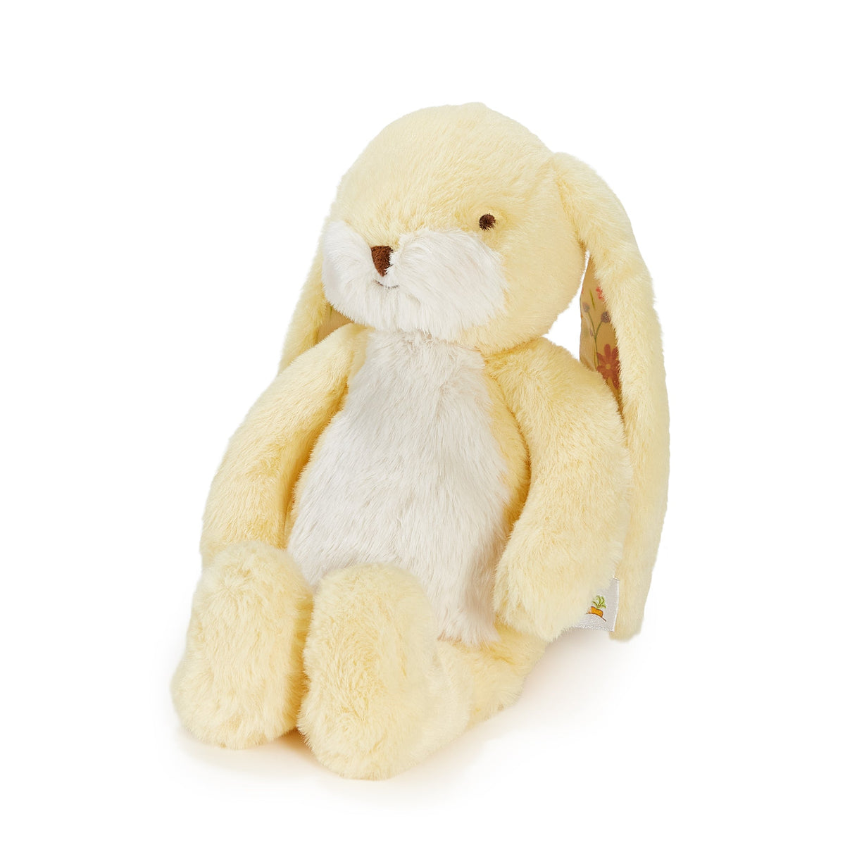 A soft plush bunny toy in pale yellow and white, photographed against a clean white background.