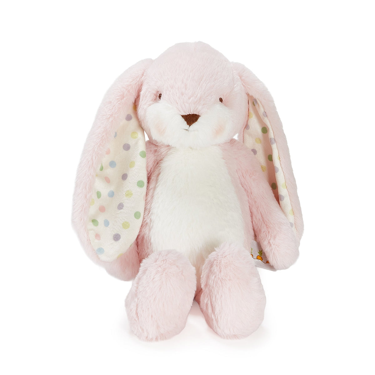 A soft plush bunny toy in light pink and white, with long floppy ears featuring pastel polka dots on a white background.